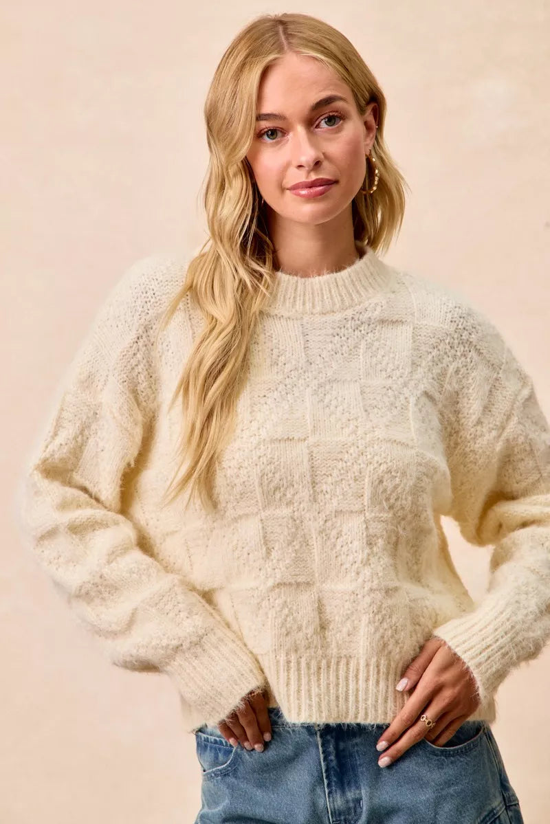 BiBi Checker Board Drop Shoulder Sweater in cream color with relaxed fit and textured design.