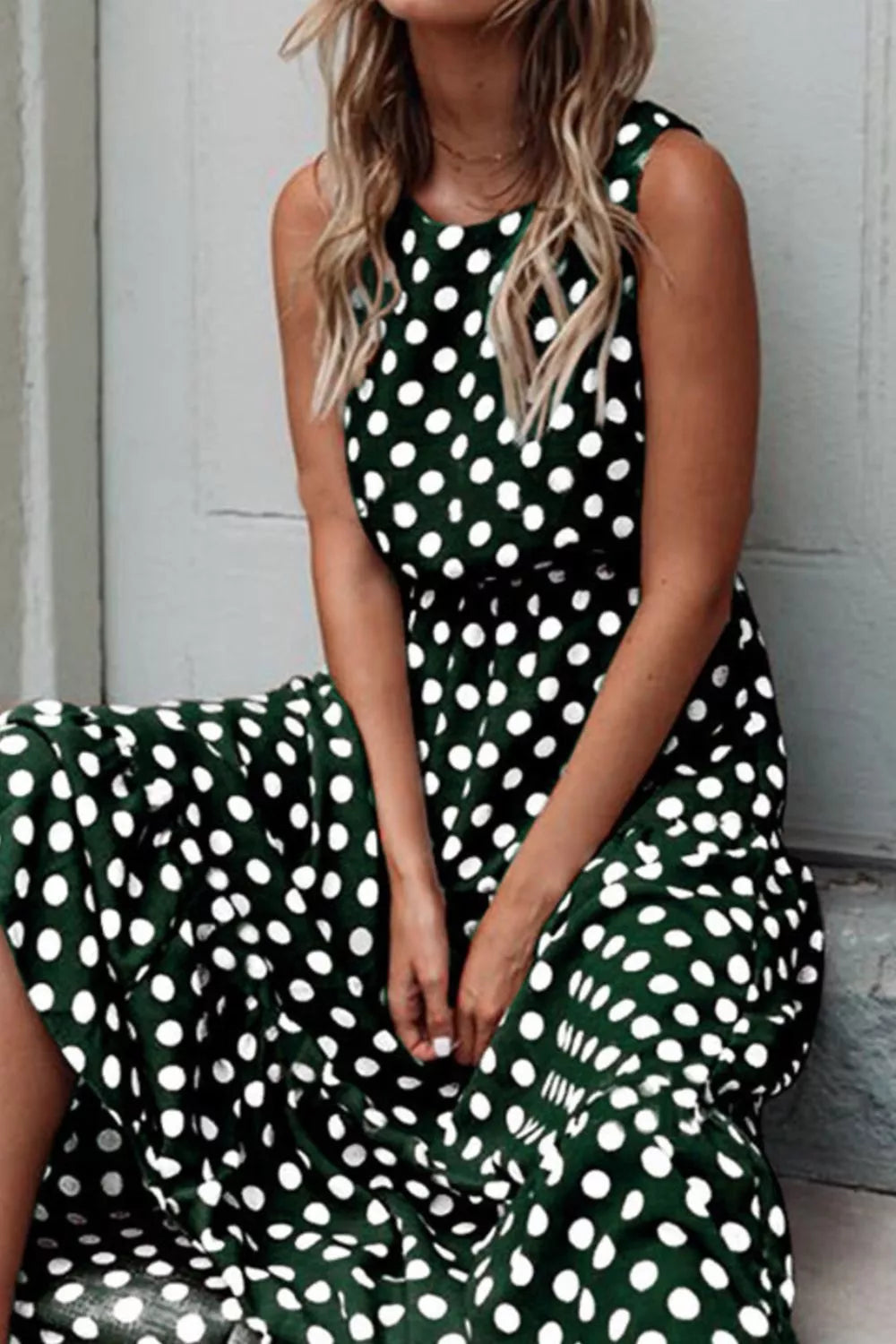 Sleeveless Polka Dot Casual Dress displayed on a model, featuring a green background with white polka dots, perfect for summer.