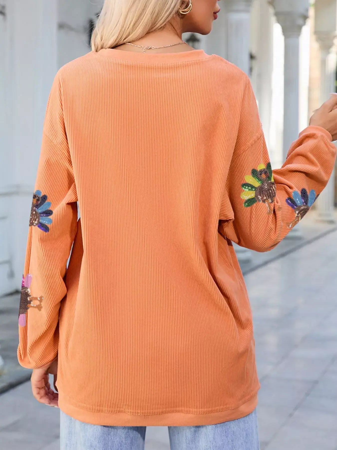 Turkey Graphic Corded Baggy Sweatshirt with colorful flower graphics on sleeves and cozy oversized fit.