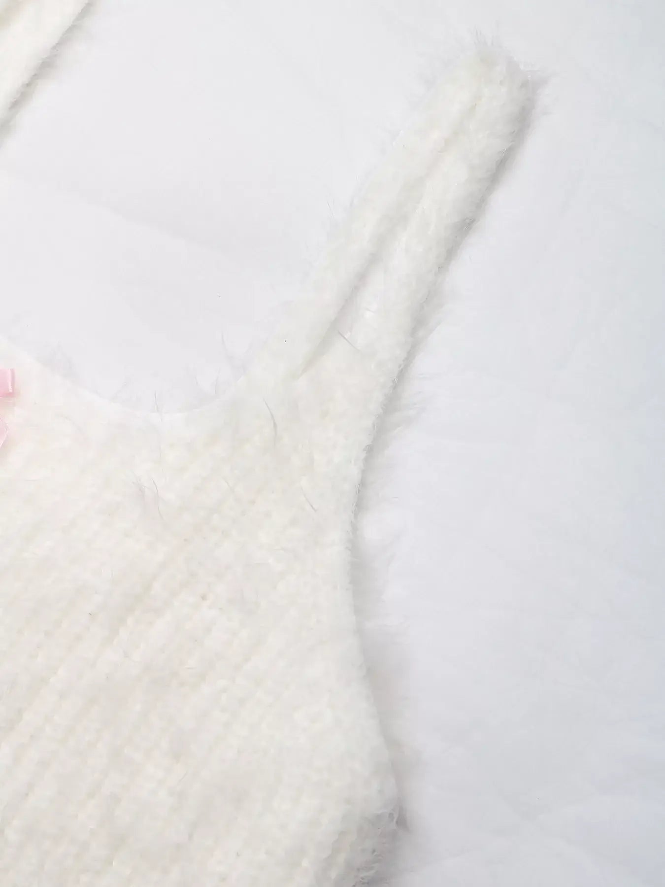 Bow Scoop Neck Cropped Cami in soft white texture with straps and bow detail on a light background.