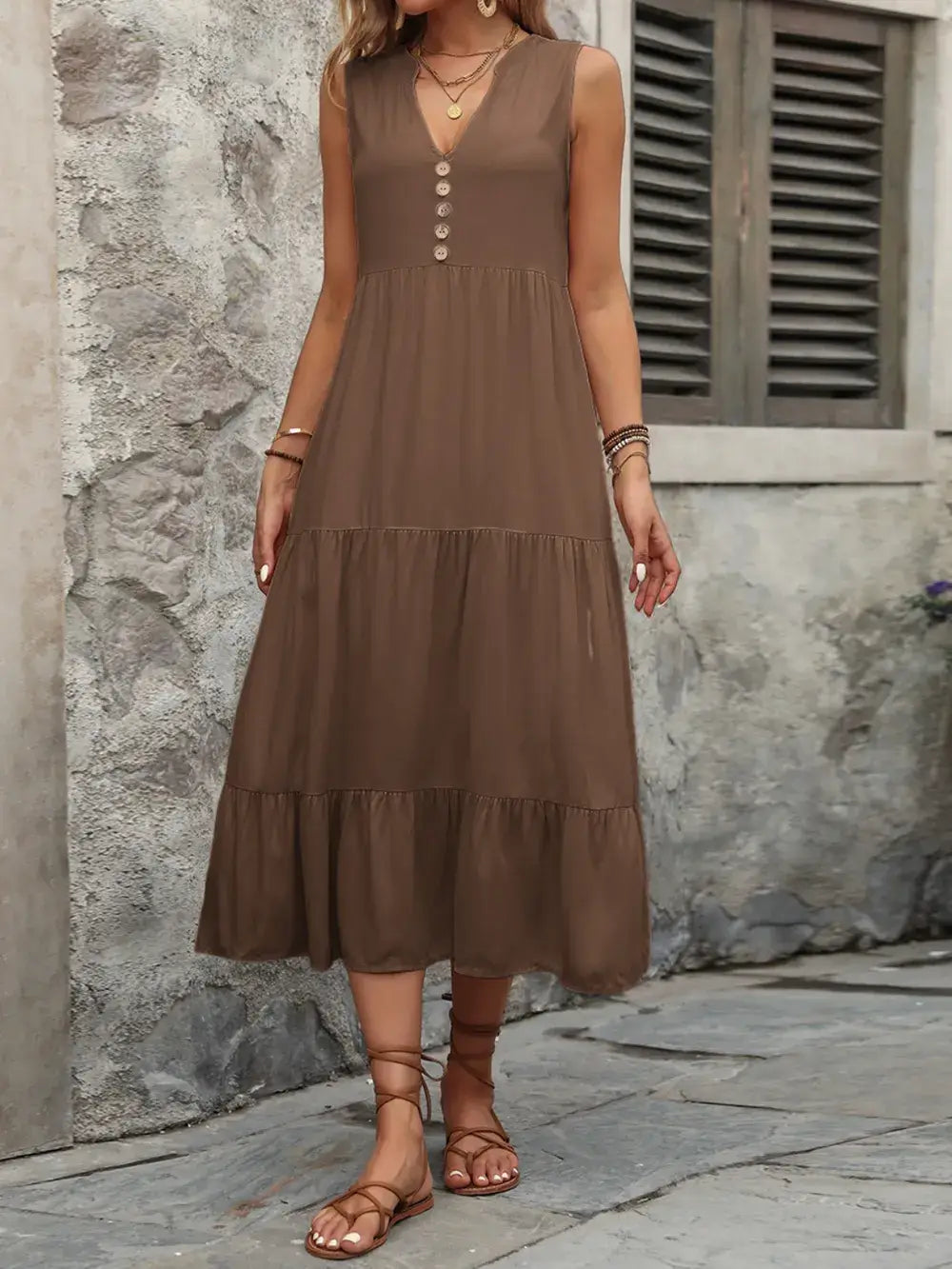 Ivy Lane Decorative Button Notched Sleeveless Dress on a model, demonstrating casual chic style in a brown color.