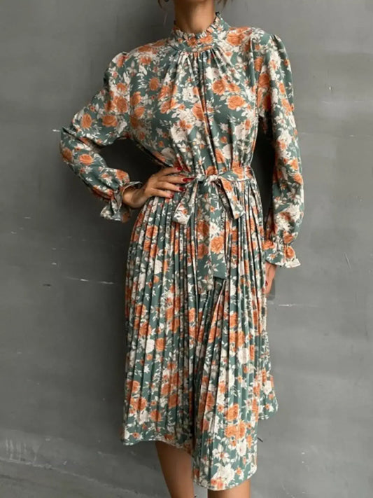Floral Print Long Sleeve Pleated Midi Dress worn by a model showcasing its elegant design and floral pattern.
