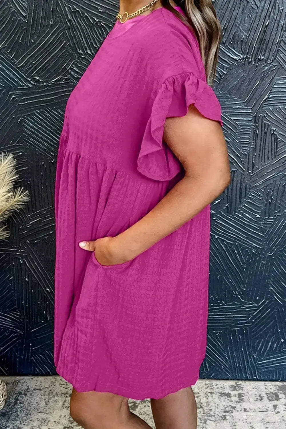 Model wearing a pink Round Neck Flounce Sleeve Mini Dress with pockets, styled for a casual look.