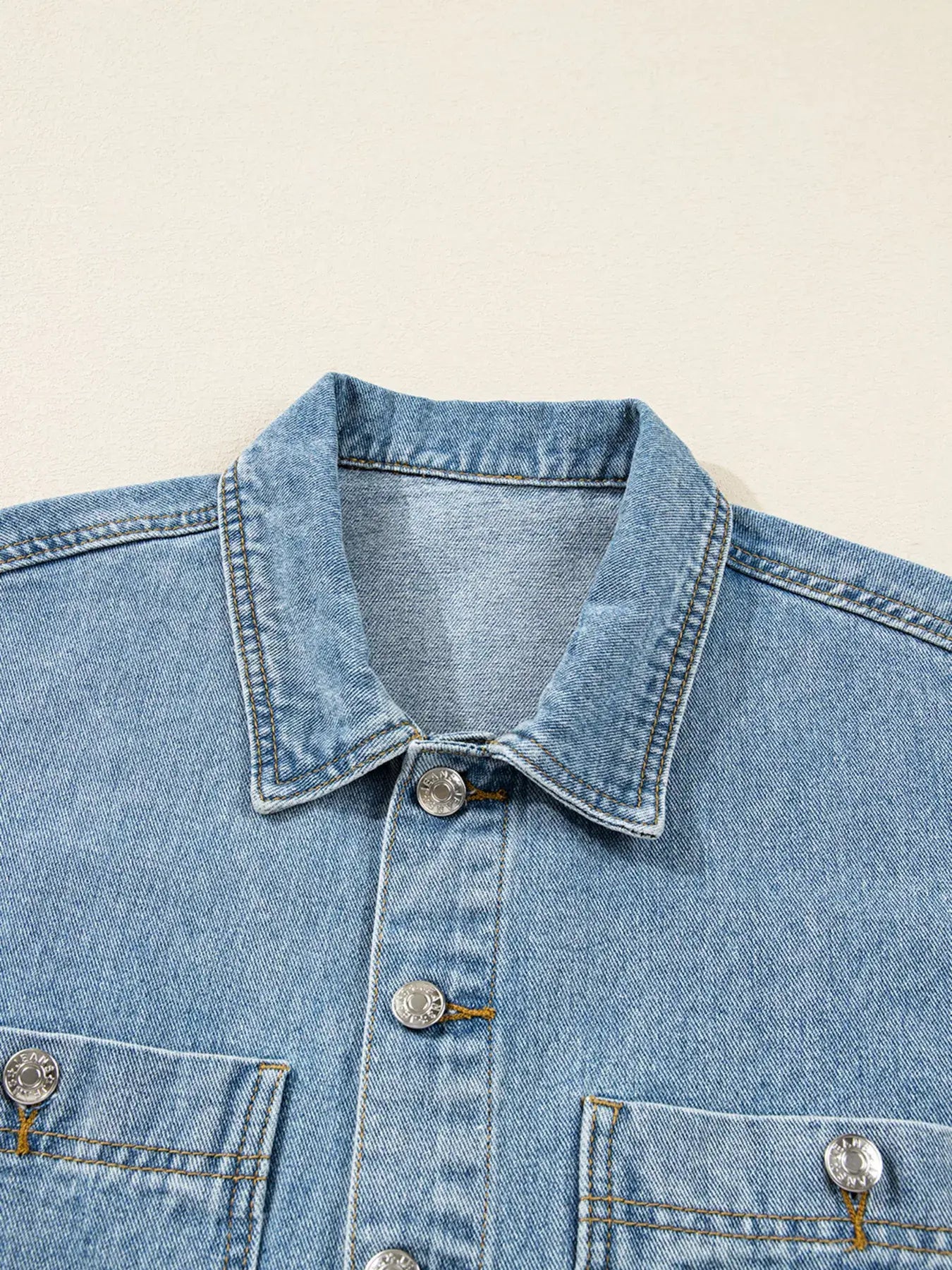 Close-up of the collar and buttons on a Patched Pockets Side Tie Denim Jacket for women.