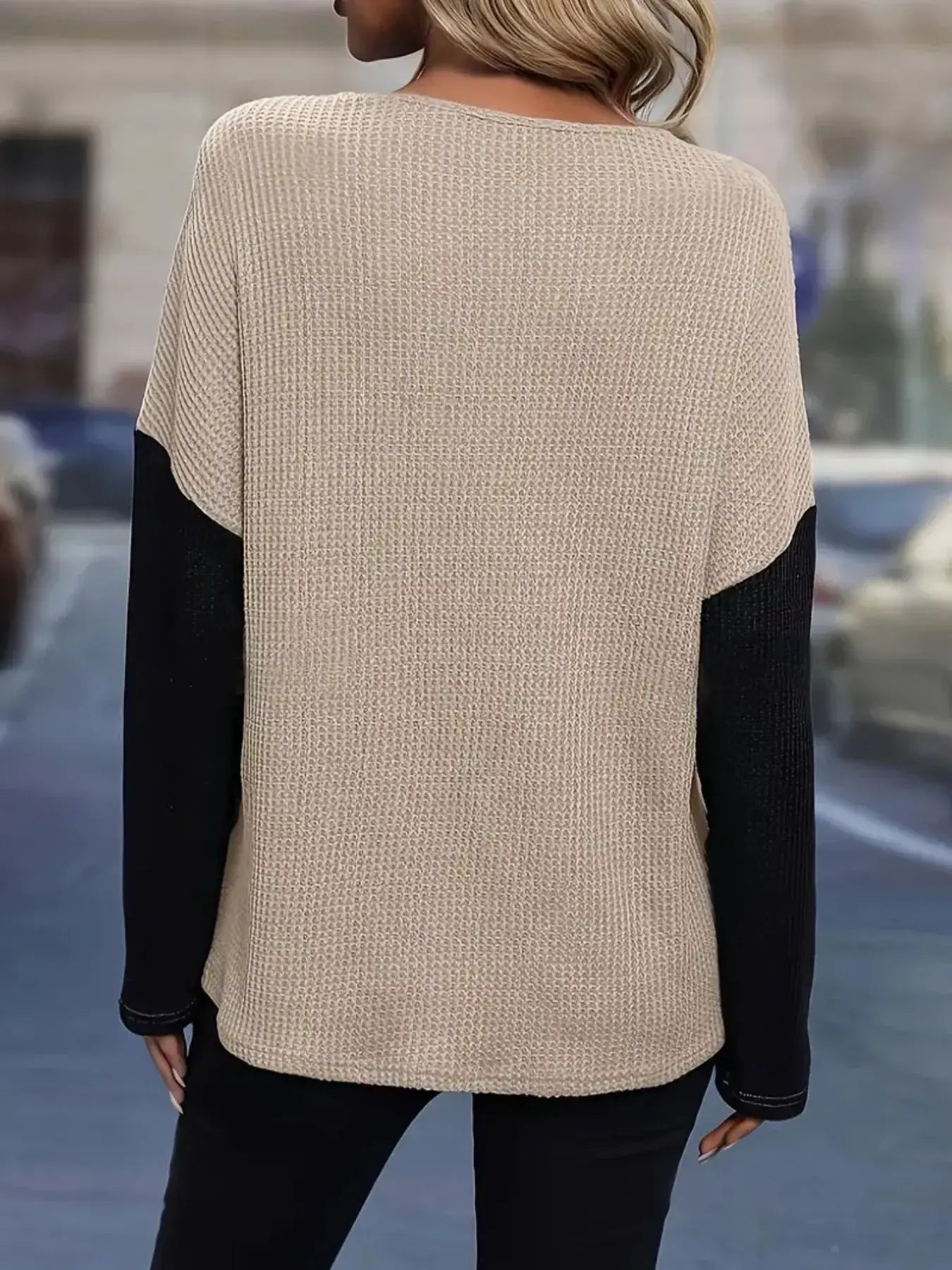 Back view of a color block long sleeve t-shirt with beige and black detailing, perfect for casual and stylish looks.