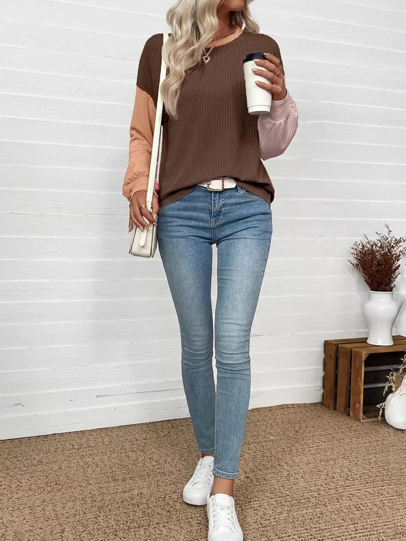 Woman wearing a Color Block Ribbed Long Sleeve T-Shirt with jeans, holding a coffee cup in a casual setting.