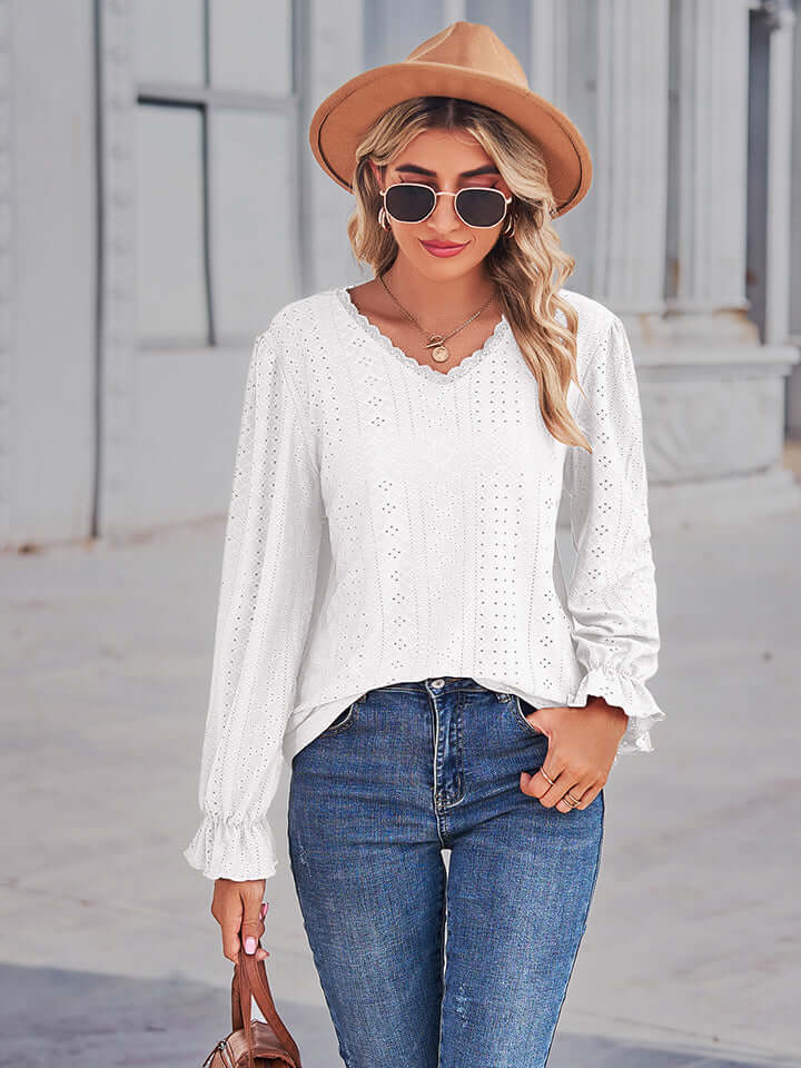 Woman wearing Eyelet V-Neck Flounce Sleeve Blouse with stylish hat and sunglasses, showcasing a feminine and elegant look.