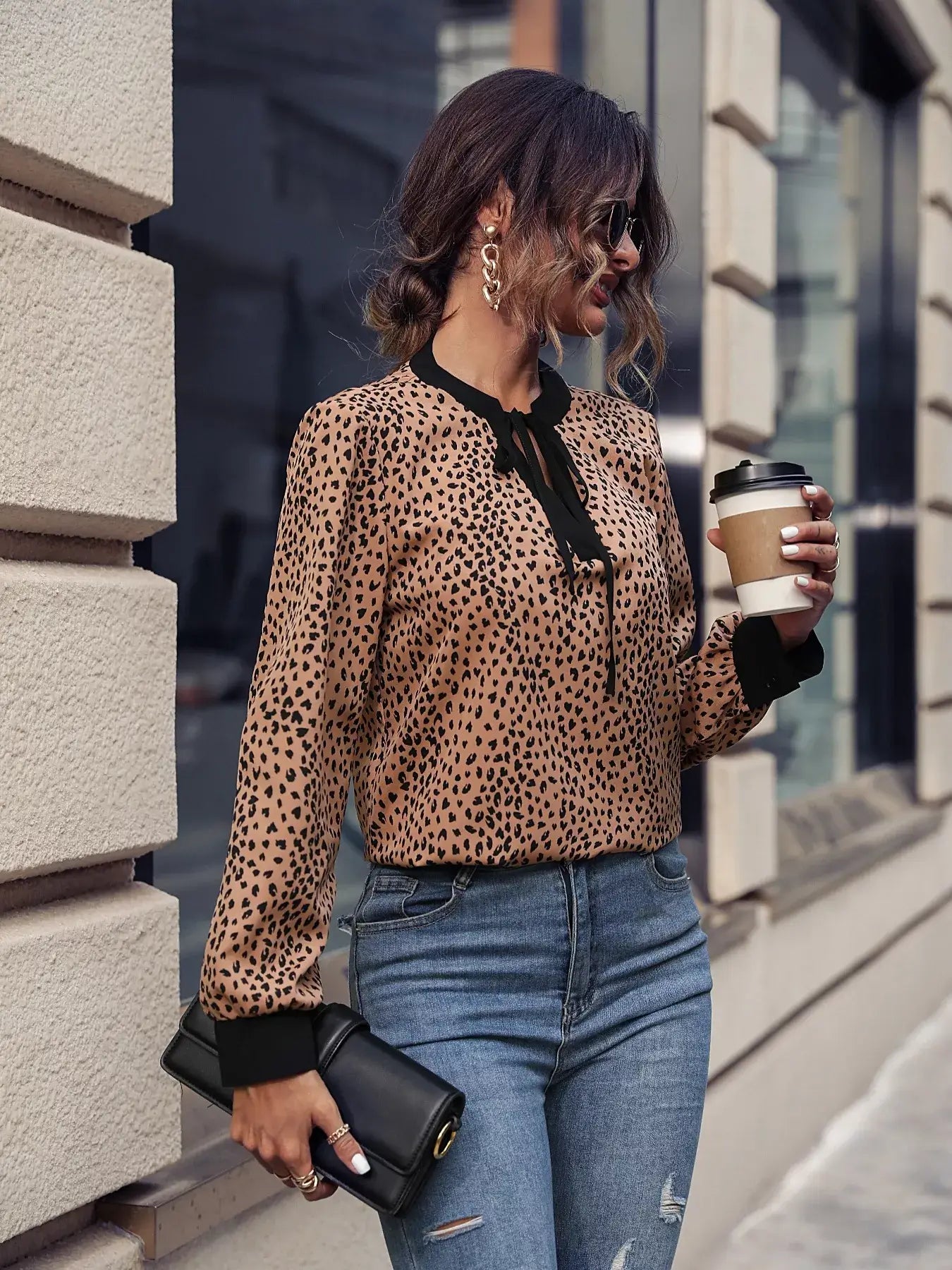 Animal Print Contrast Trim Tie Front Blouse – Bold & Stylish worn by a woman holding coffee in urban setting.