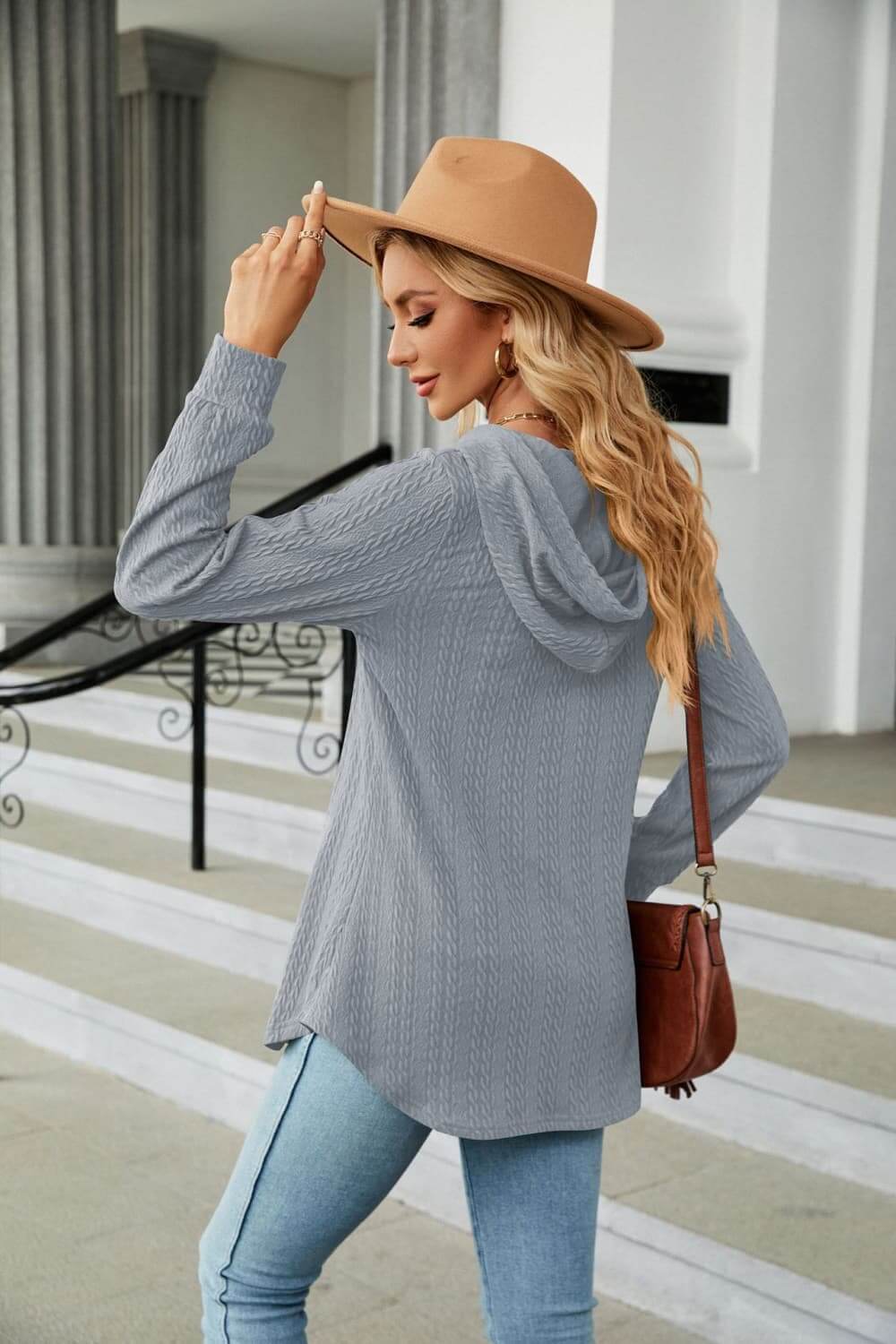 Long Sleeve Hooded Blouse in gray worn by a woman with a hat, showcasing casual style and comfort.