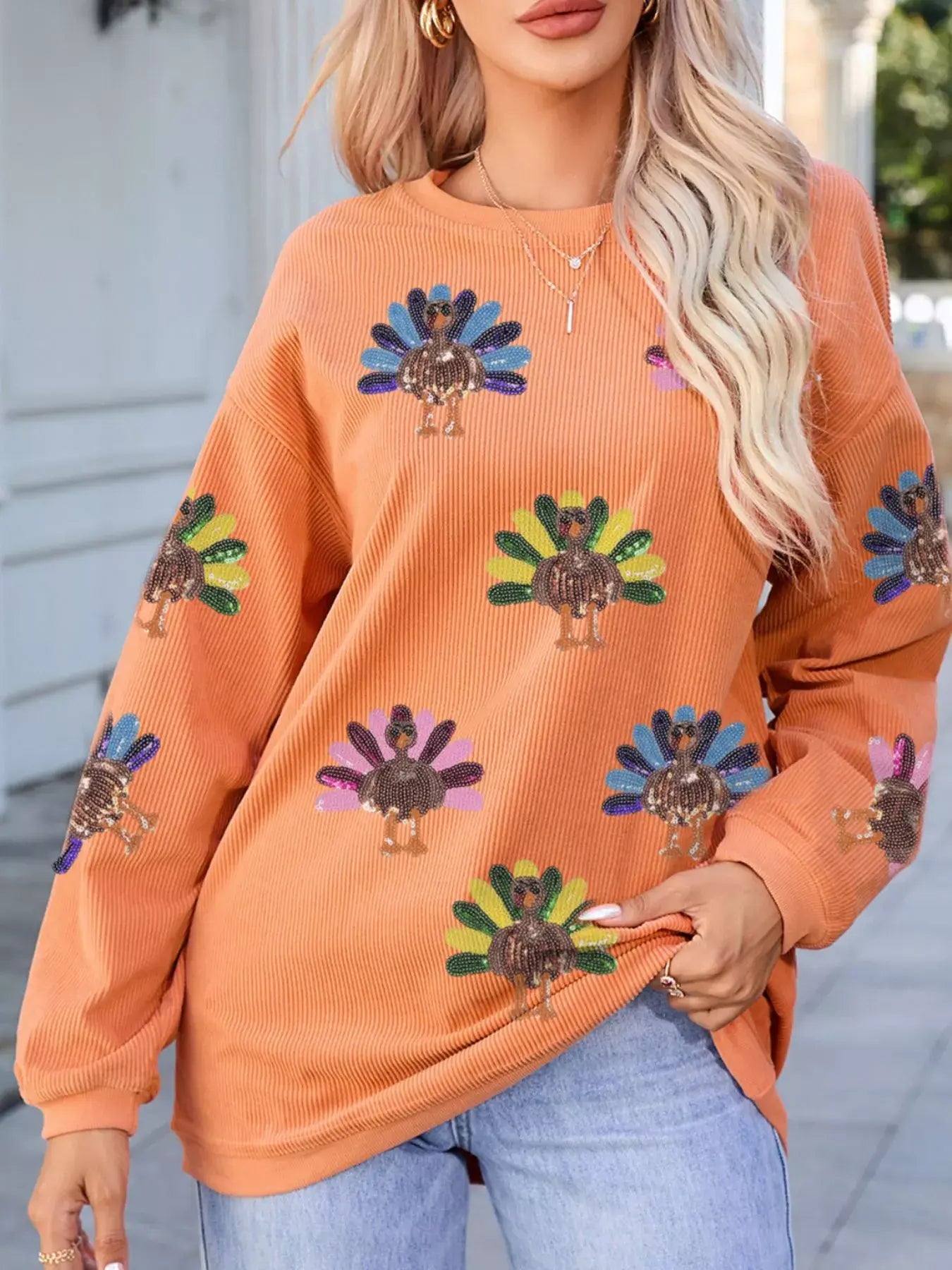 Turkey Graphic Corded Baggy Sweatshirt featuring colorful turkey graphics on a cozy oversized design.