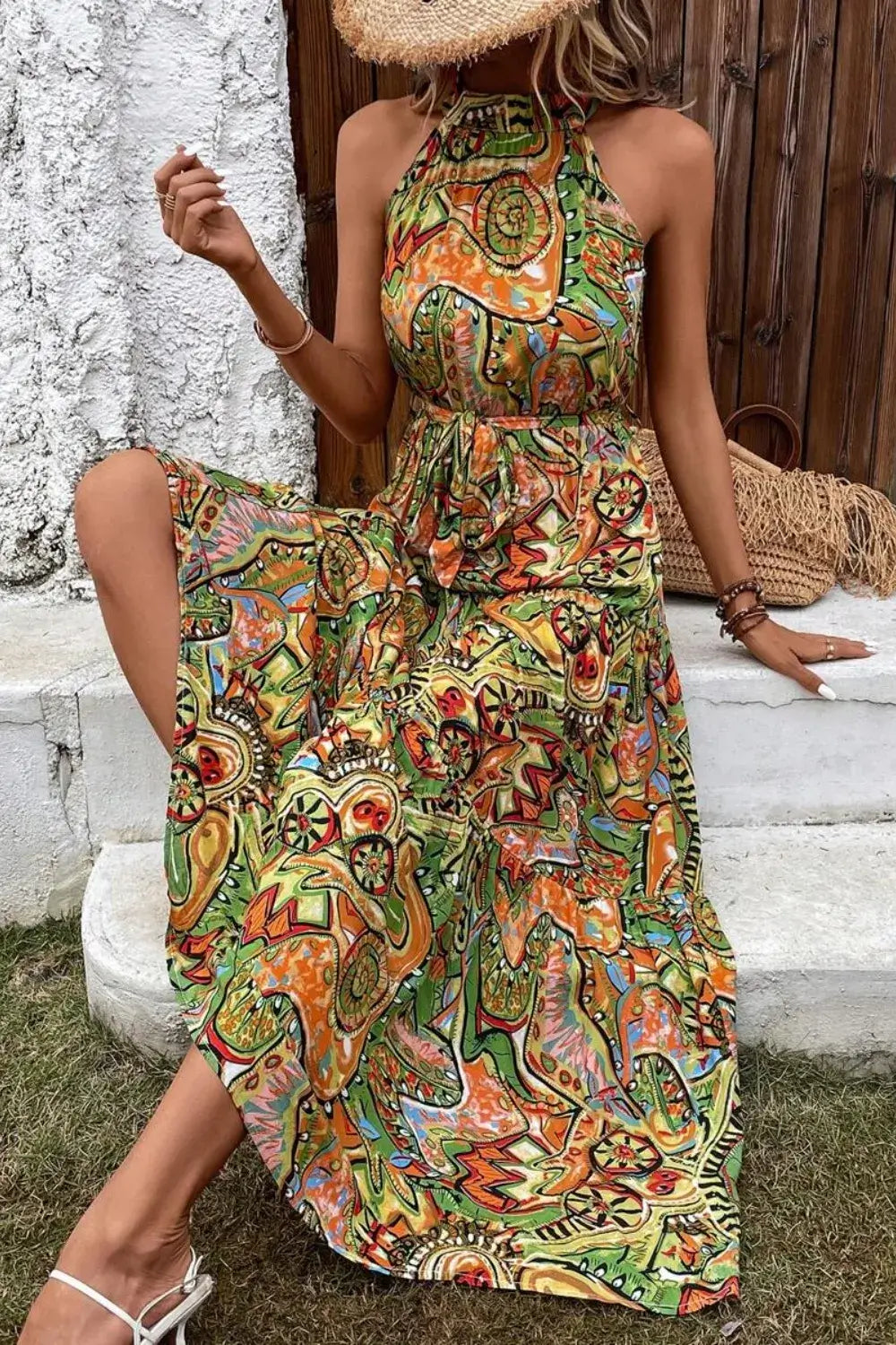 Model wearing Tied Floral Sleeveless Dress in vibrant colors, featuring a halter neck and flowing design perfect for summer.