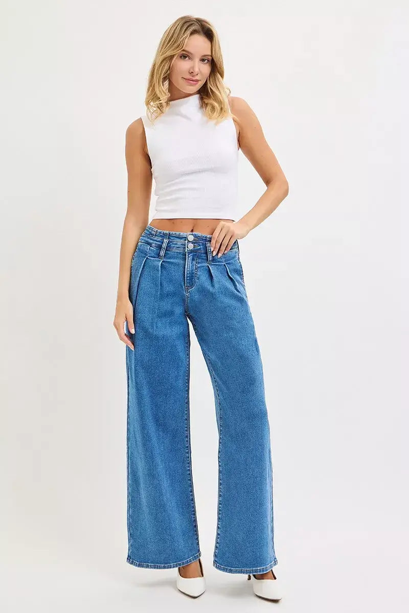 Model wearing RISEN Plus Size Pleated Wide Leg Jeans with a mid-rise fit and stylish white top.
