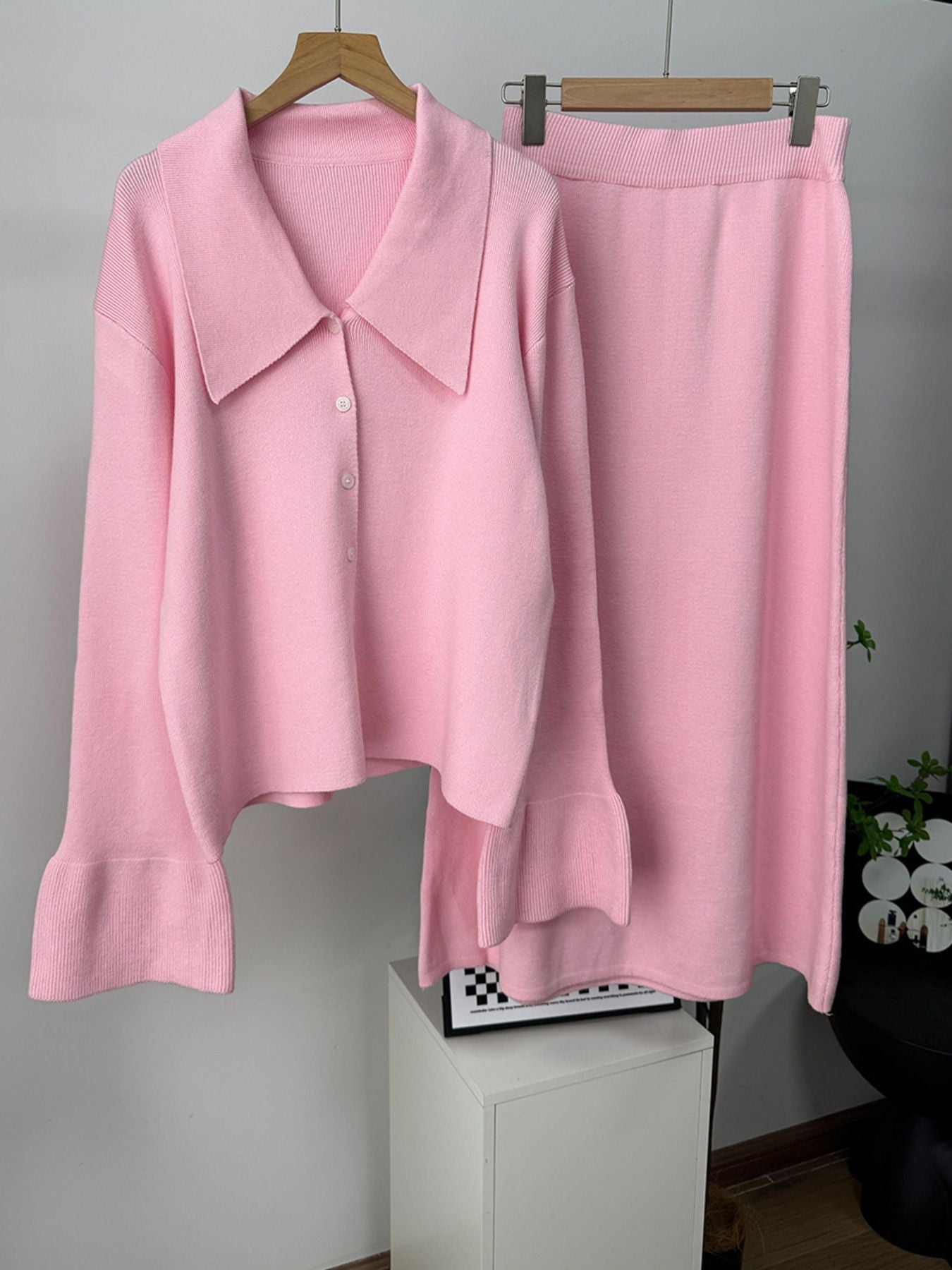 Button Down Cardigan and Skirt Knit Set in soft pink, featuring a ribbed design and button-up details.