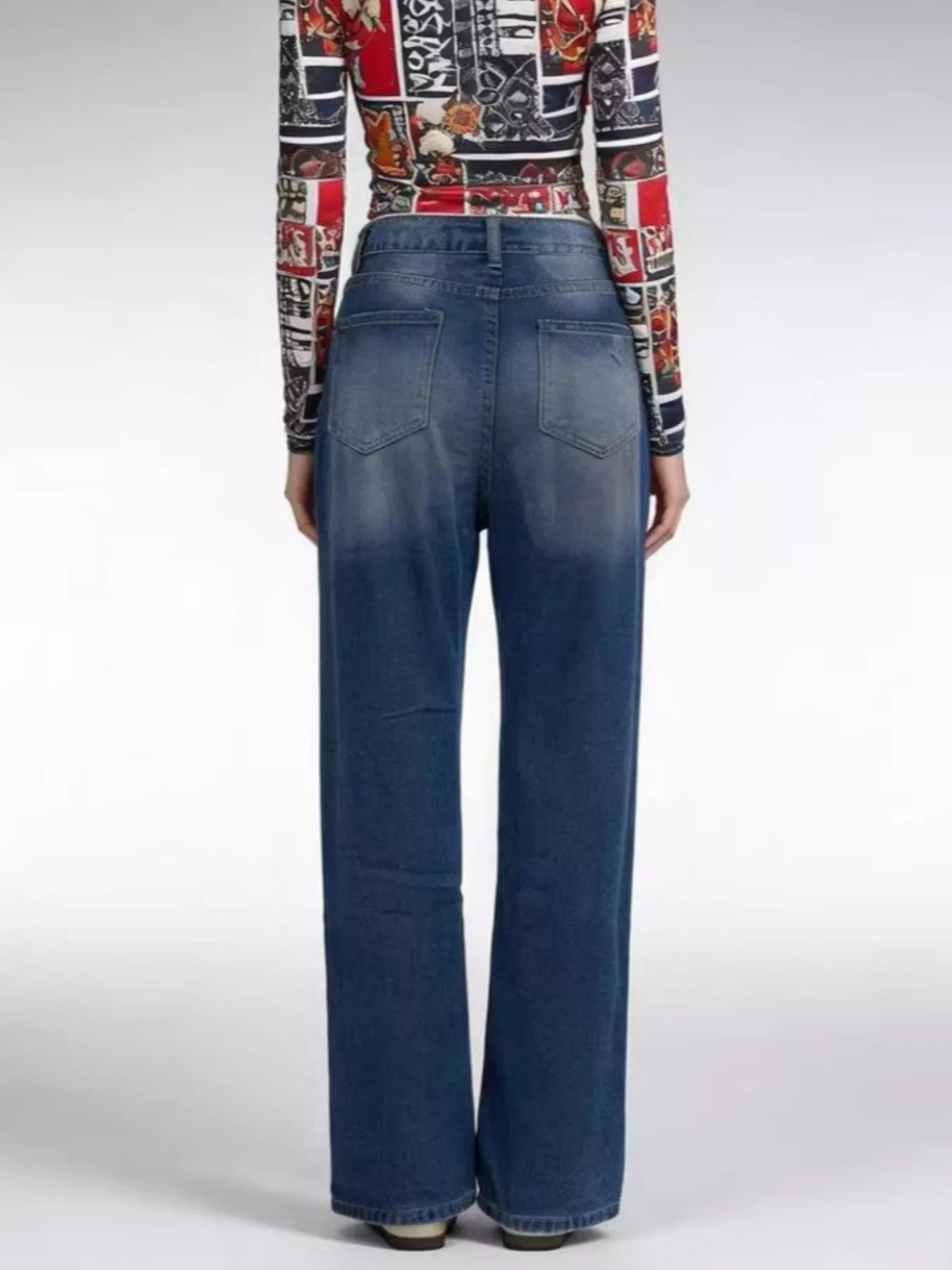 Back view of Distressed Wide Leg Jeans showcasing buttoned pocketed design and relaxed fit.