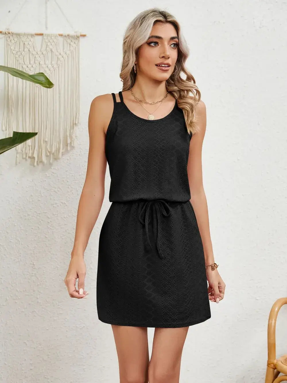 Model wearing a black Eyelet Scoop Neck Sleeveless Dress with a drawstring waist, perfect for casual summer days.