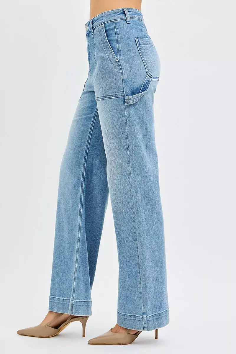 Side view of RISEN High Rise Straight Leg Jeans Plus Size in light blue, featuring front pockets and a flattering silhouette.