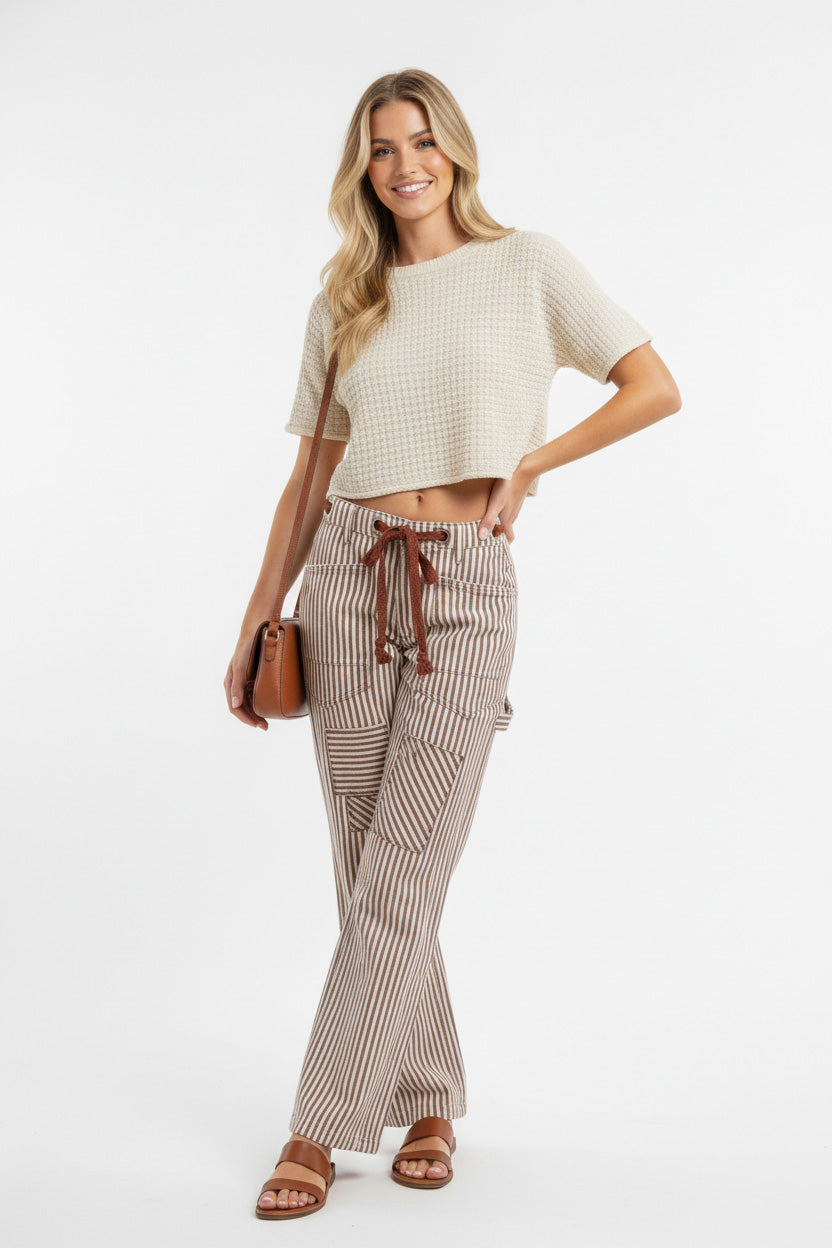 Model wearing Drawstring Striped Twill Barrel Pants with a cropped top and a handbag, showcasing a stylish casual look.