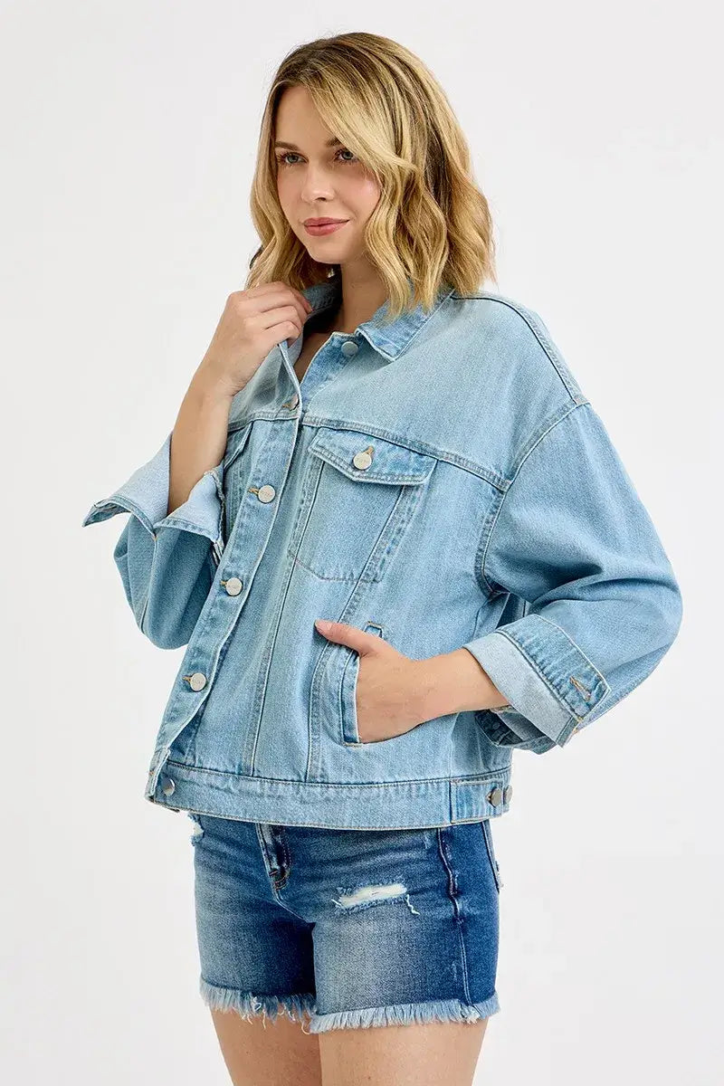 Model wearing RISEN Washed Dropped Shoulder Denim Jacket with casual shorts and styled for streetwear.