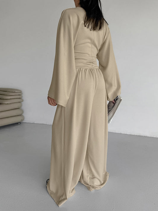 Back view of a model wearing a beige Round Neck Top and Wide Leg Pants Set showcasing its stylish design.