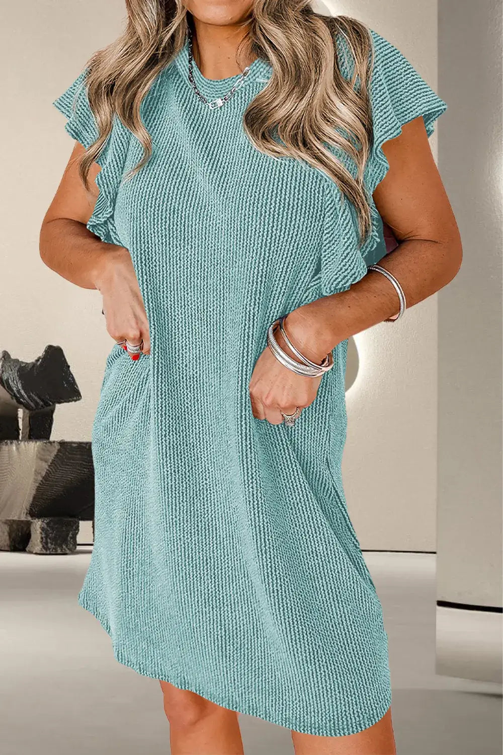 Textured ruffled round neck cap sleeve dress in teal, featuring pockets and stylish ruffles.