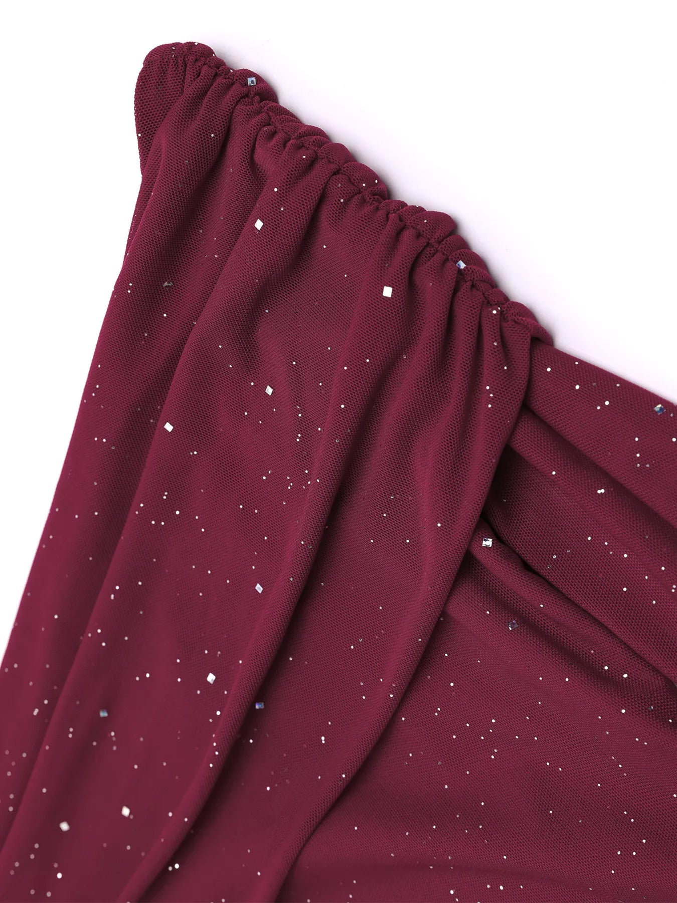 Glitter Off-Shoulder Maxi Dress fabric close-up featuring a rich burgundy color with shimmering glitter details.