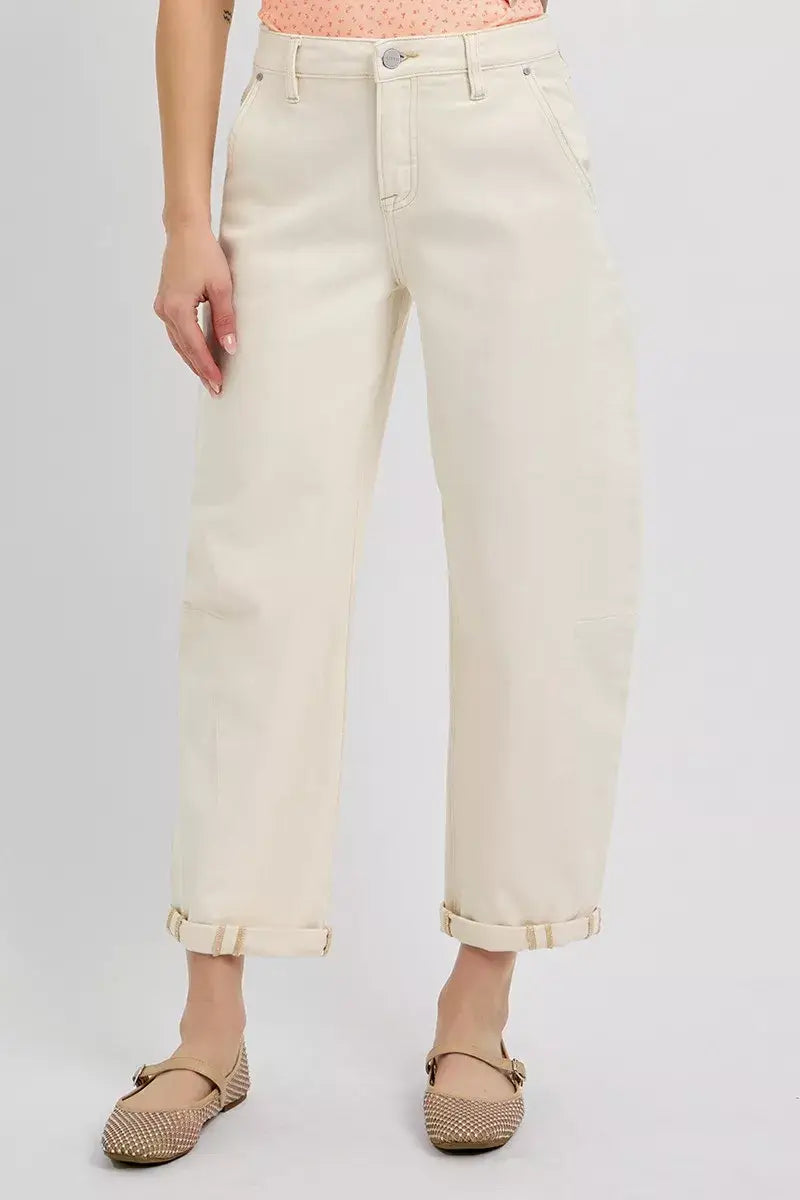 Model wearing RISEN High Rise Relaxed Barrel Cuffed Jeans in light beige with rolled cuffs and stylish flats.