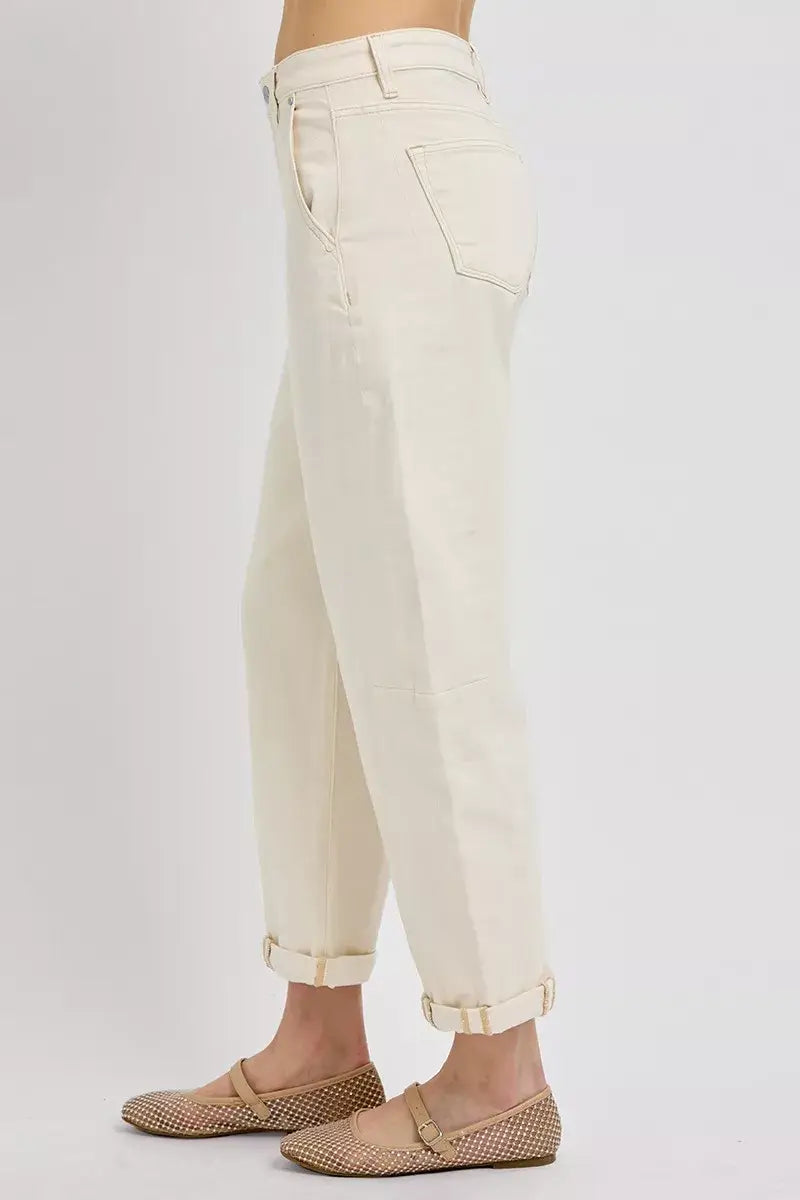Side view of RISEN High Rise Relaxed Barrel Cuffed Jeans in cream color, showcasing a relaxed fit and cuffed hem.