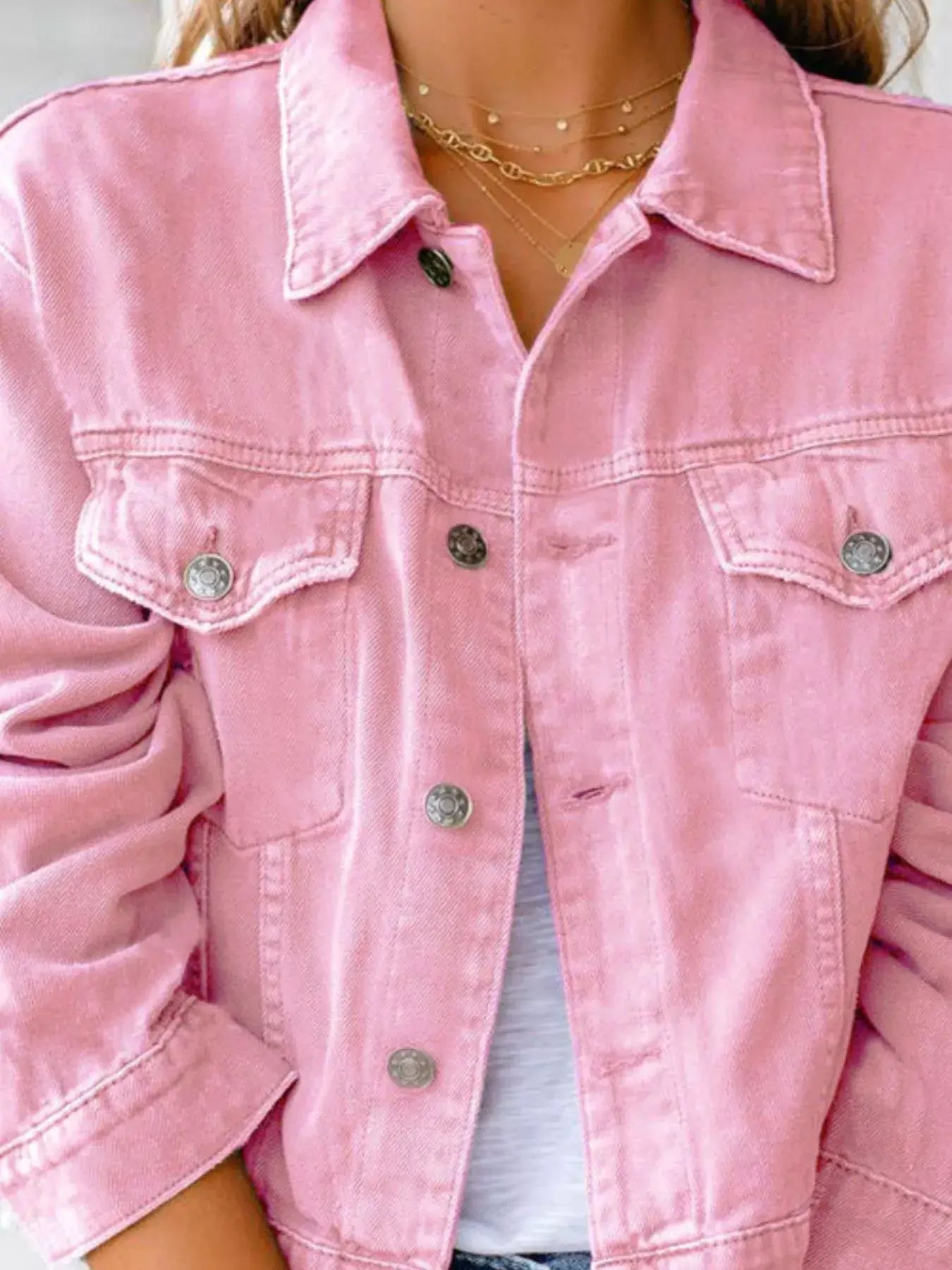 Pink button-up long sleeve denim jacket for women, featuring front pockets and a classic design.