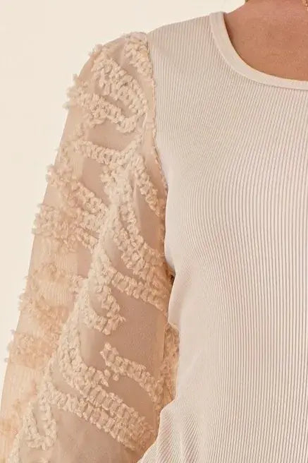 Textured puff sleeve bodysuit featuring elegant lace detail and stylish puff sleeves.