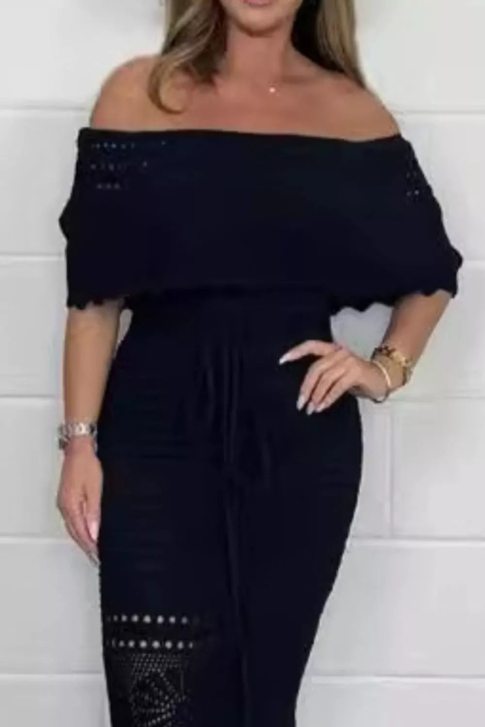 Woman modeling a Crochet Off-Shoulder Maxi Dress in black, showcasing its elegant summer style and cutout design.