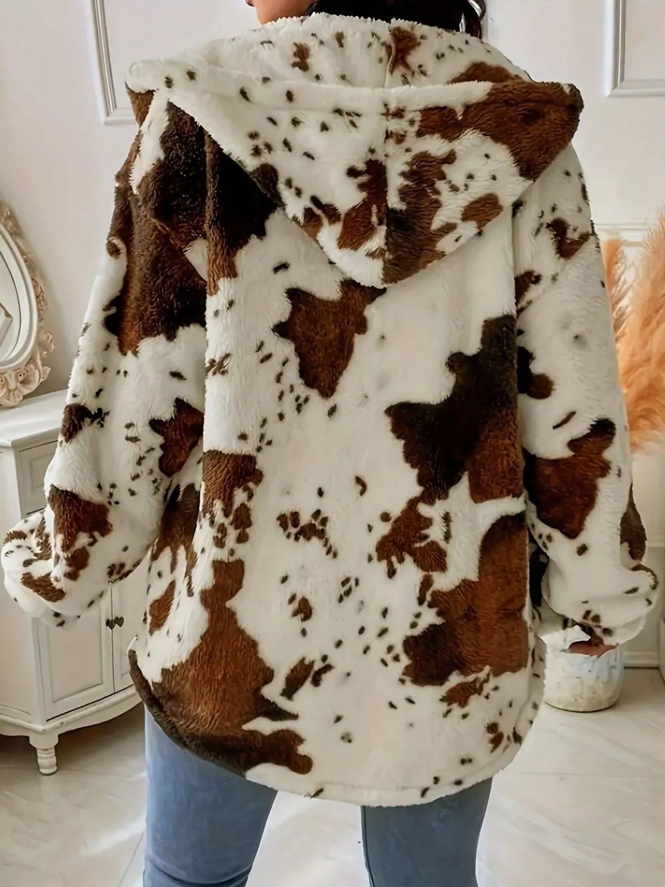 Back view of a cozy Cow Print Plush Hooded Jacket, featuring soft plush fabric and a stylish hood.