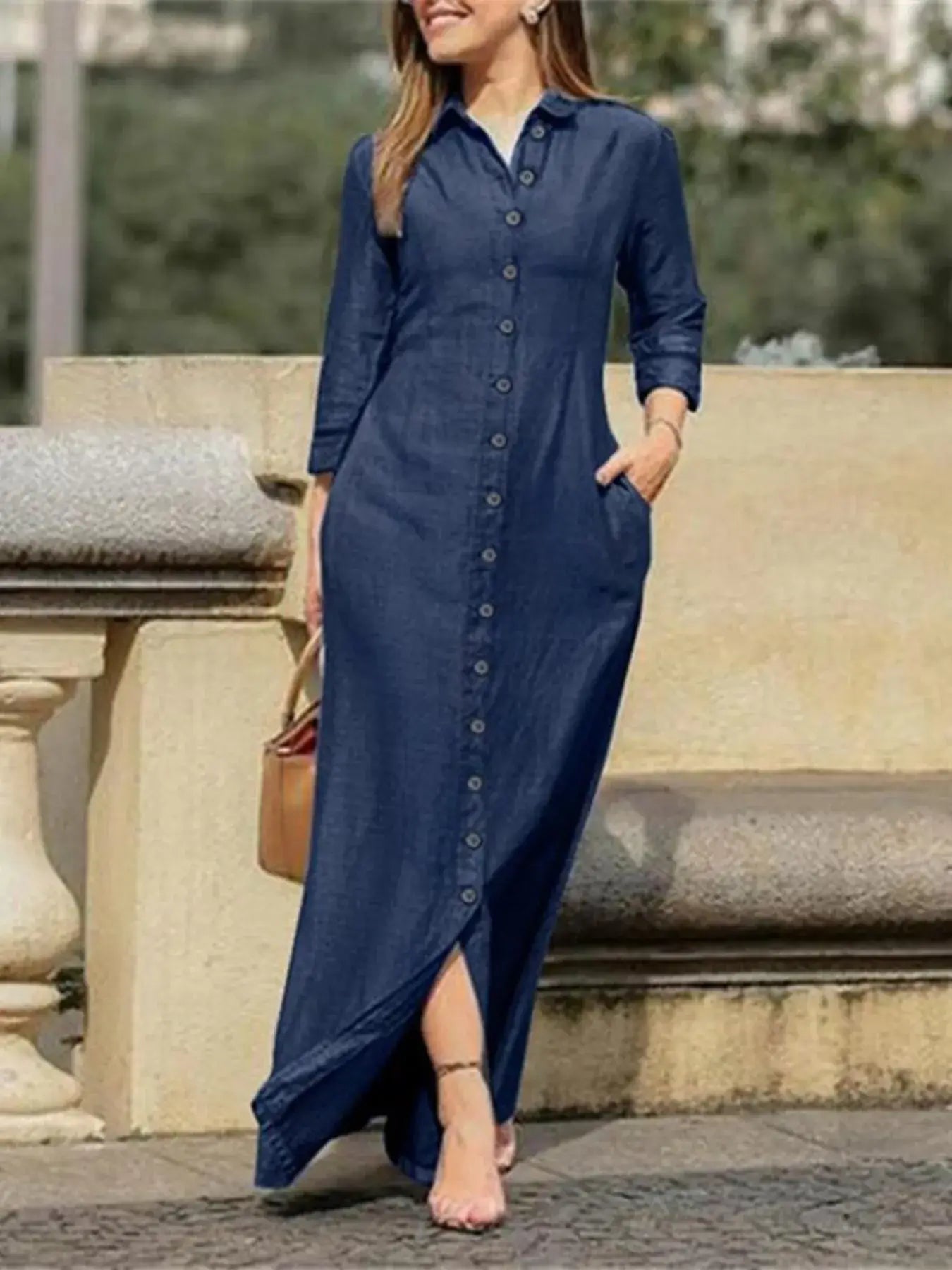Model wearing a full size button-down maxi denim dress with pockets and a stylish slit.