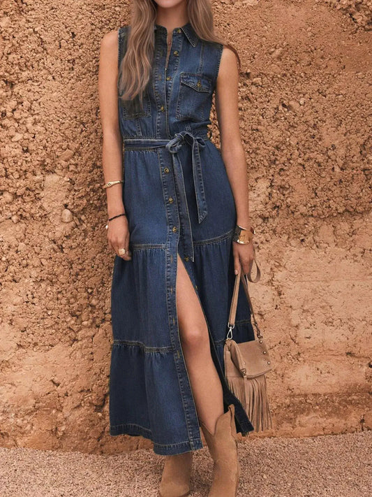 Women wearing a Button Front Sleeveless Denim Dress with belted waist, featuring an A-line cut and stylish slit.