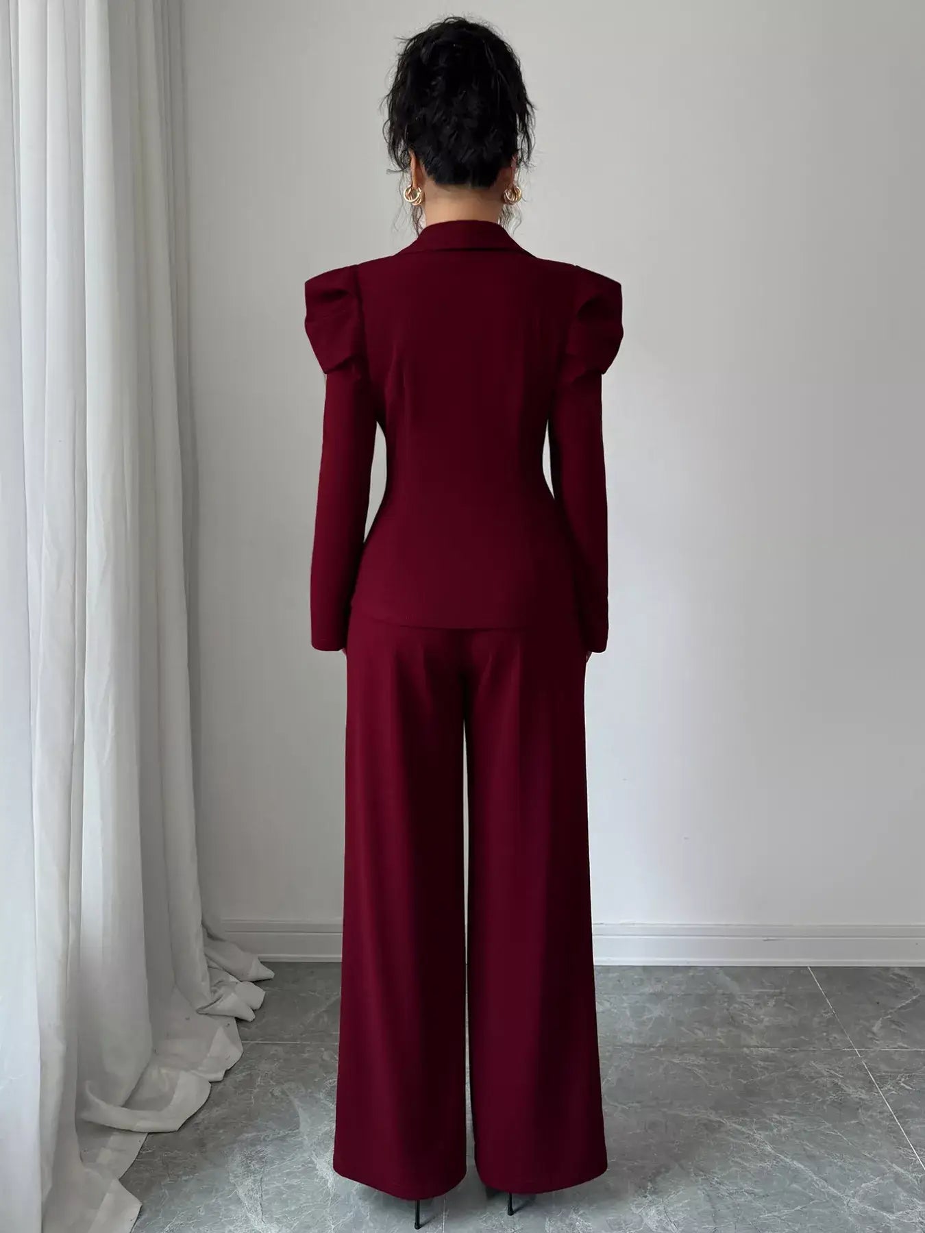 Back view of a model wearing a Double-Breasted Blazer and Pants Suit Set in burgundy, showcasing modern elegance.