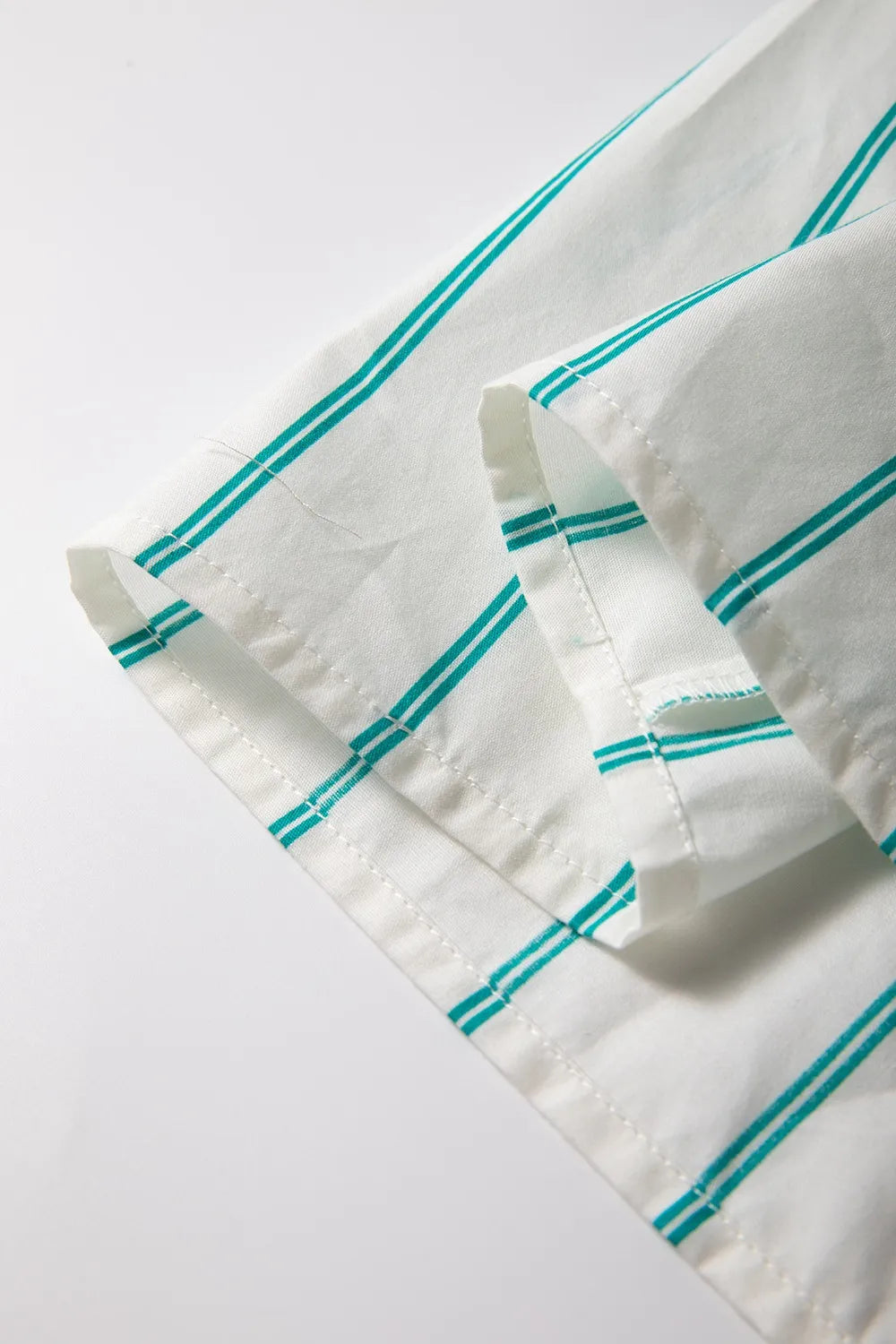 Close-up of the fabric showing the St Patricks Striped Wide Short Sleeve Shift Mini Shirt Dress with teal stripes.