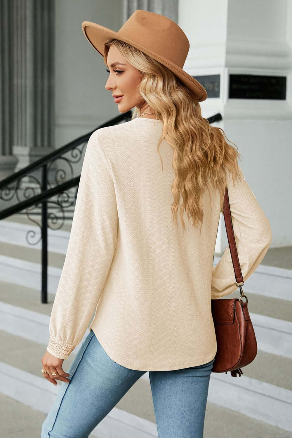 Back view of a woman wearing a V-Neck Long Sleeve Blouse with a hat, showcasing casual and elegant style.