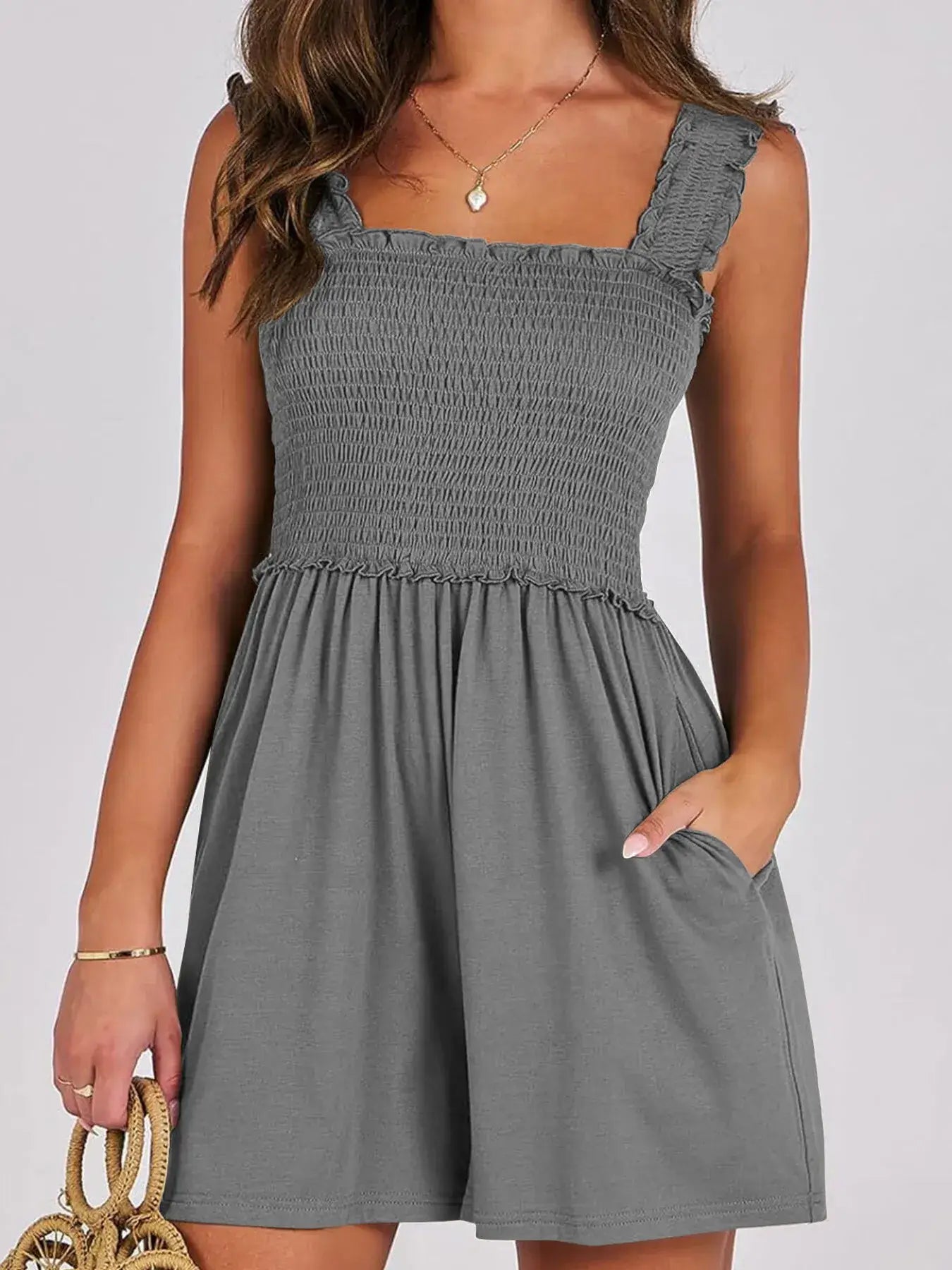 Smocked Square Neck Summer Romper in gray with smocked bodice and ruffled edges, featuring pockets and a square neckline.