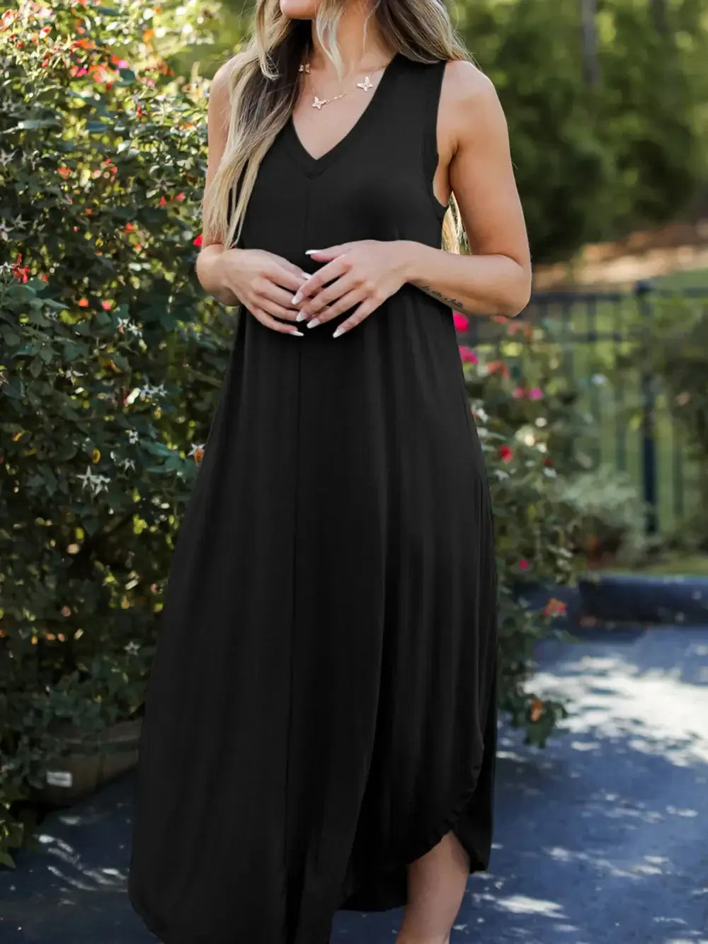 Full Size V-Neck Midi Tank Dress worn by a woman in a garden, showcasing its casual and chic style.