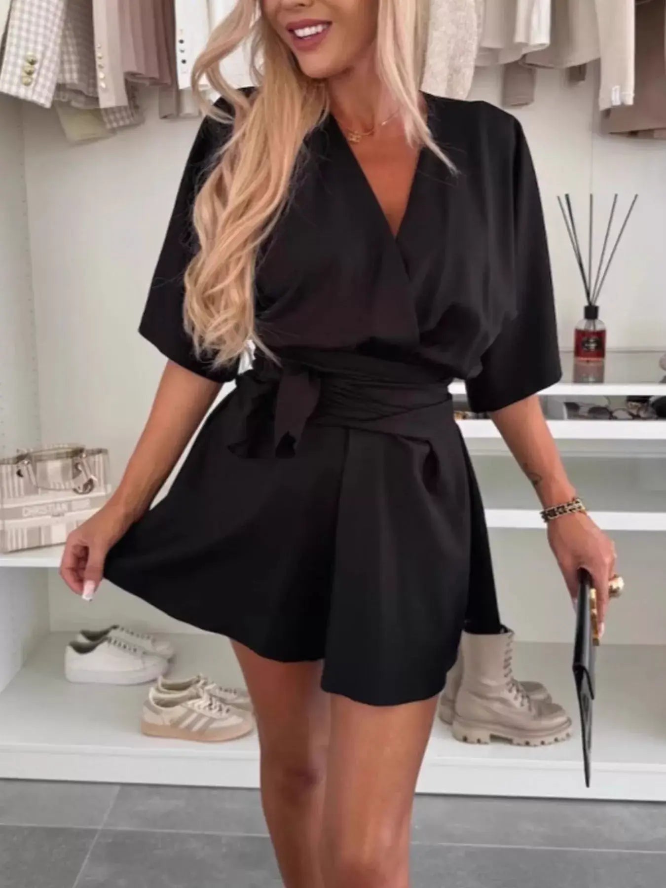 Full Size Surplice Tie Waist Romper worn by a woman with long hair, showcasing a chic look with a relaxed fit and tie waist.