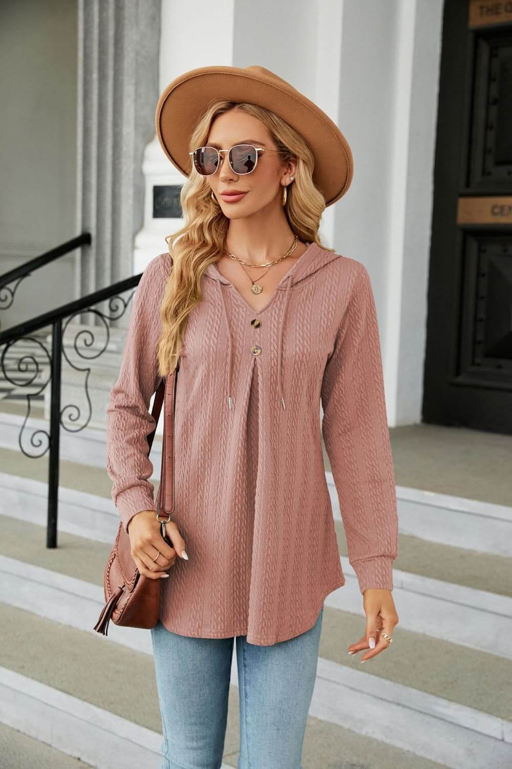 Long Sleeve Hooded Blouse in dusty pink worn with jeans and a hat, showcasing casual style and cozy comfort.