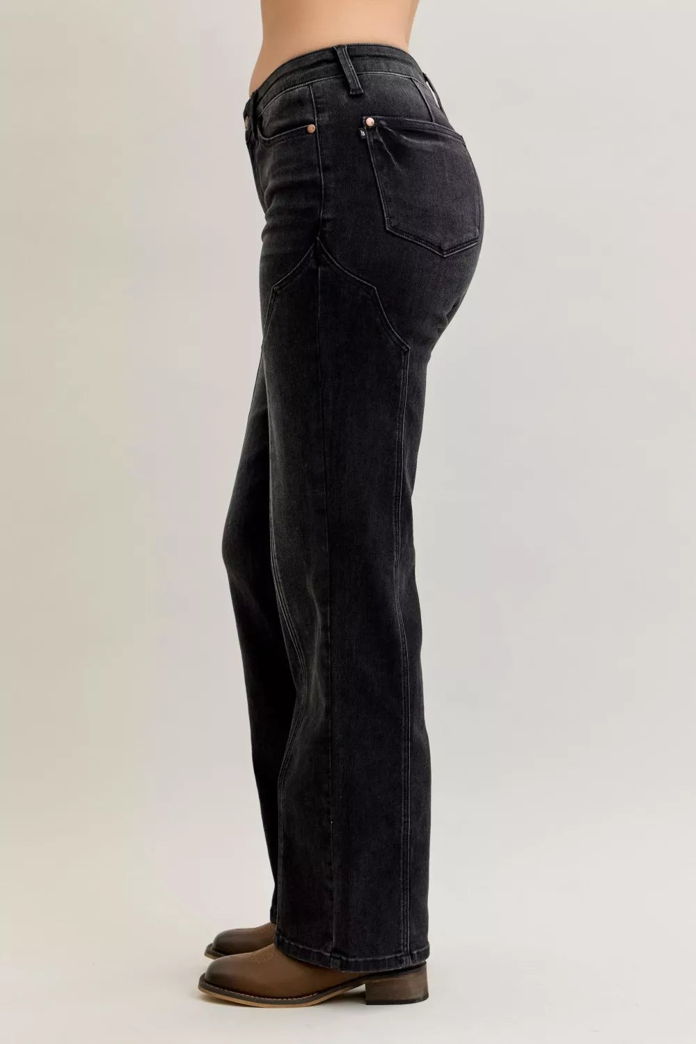 Judy Blue Mid Rise Straight Western Seam Jeans shown in side view on model, highlighting stylish denim design.