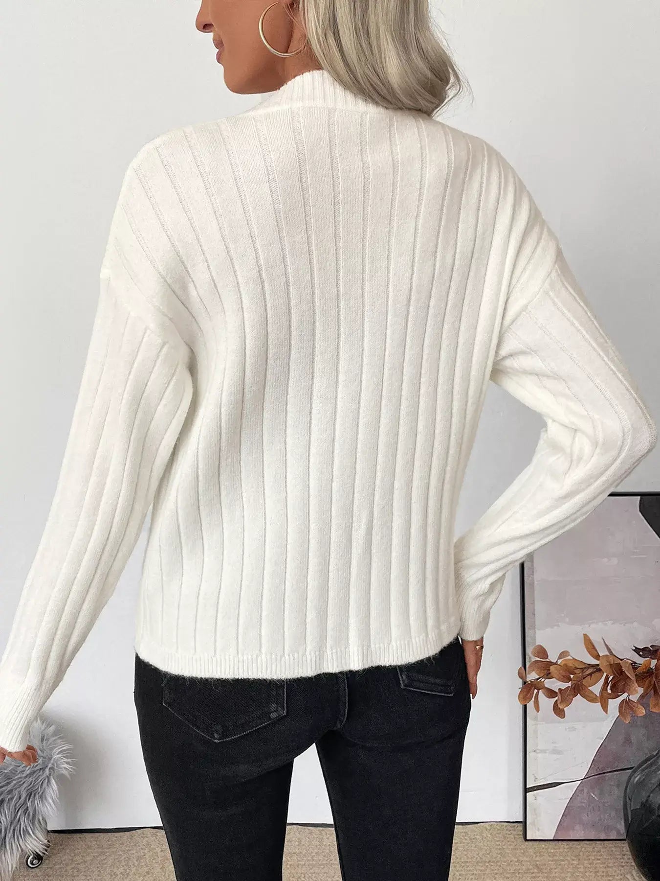 Back view of a woman wearing a Ribbed Button Up Long Sleeve Cardigan, showcasing its ribbed texture and casual style.