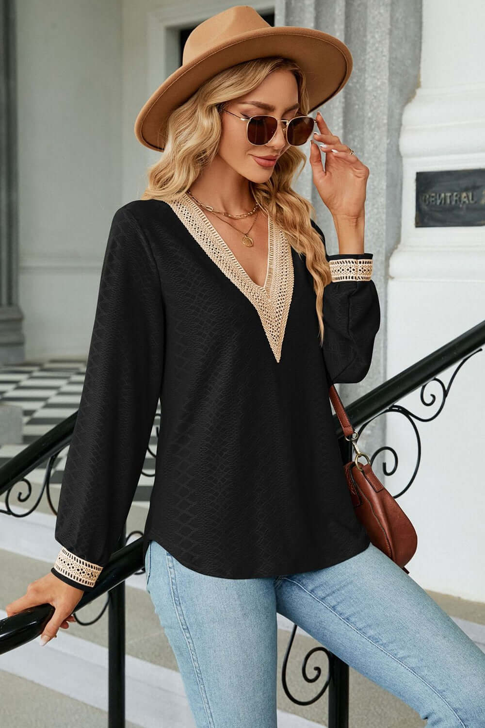 V-Neck Long Sleeve Blouse worn by a fashionable woman with a hat and sunglasses, showcasing casual elegance.