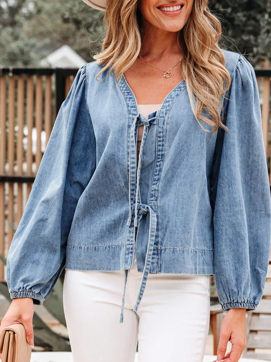 Tied Front Puff Sleeve Denim Top for Women with dramatic puff sleeves and a chic tie-front design, styled with white pants.