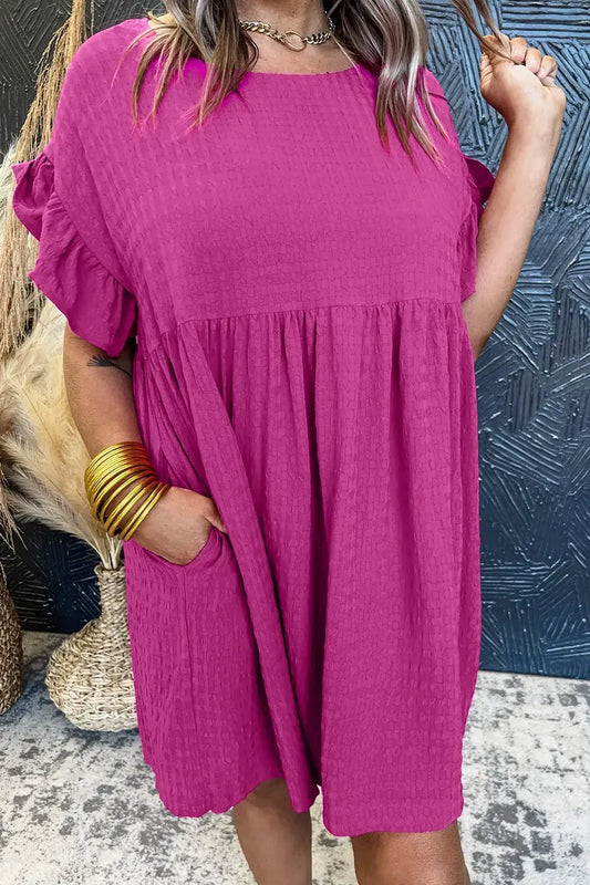 Model wearing a vibrant pink Round Neck Flounce Sleeve Mini Dress with pockets, showcasing a stylish and casual look.