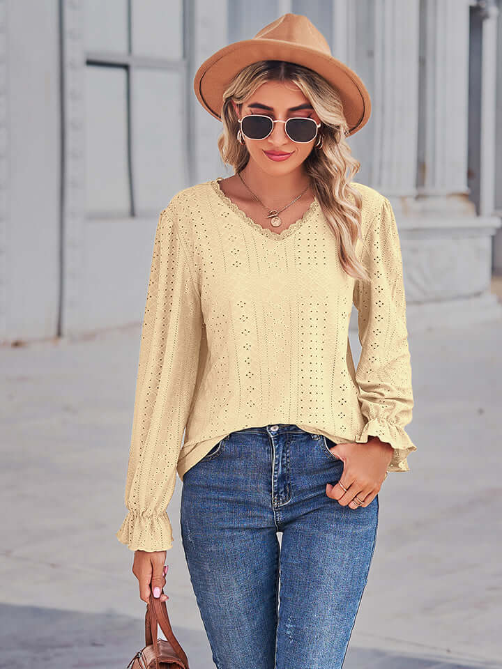 Woman wearing Eyelet V-Neck Flounce Sleeve Blouse in yellow with flounce sleeves and a V-neck, styled with jeans and a hat.