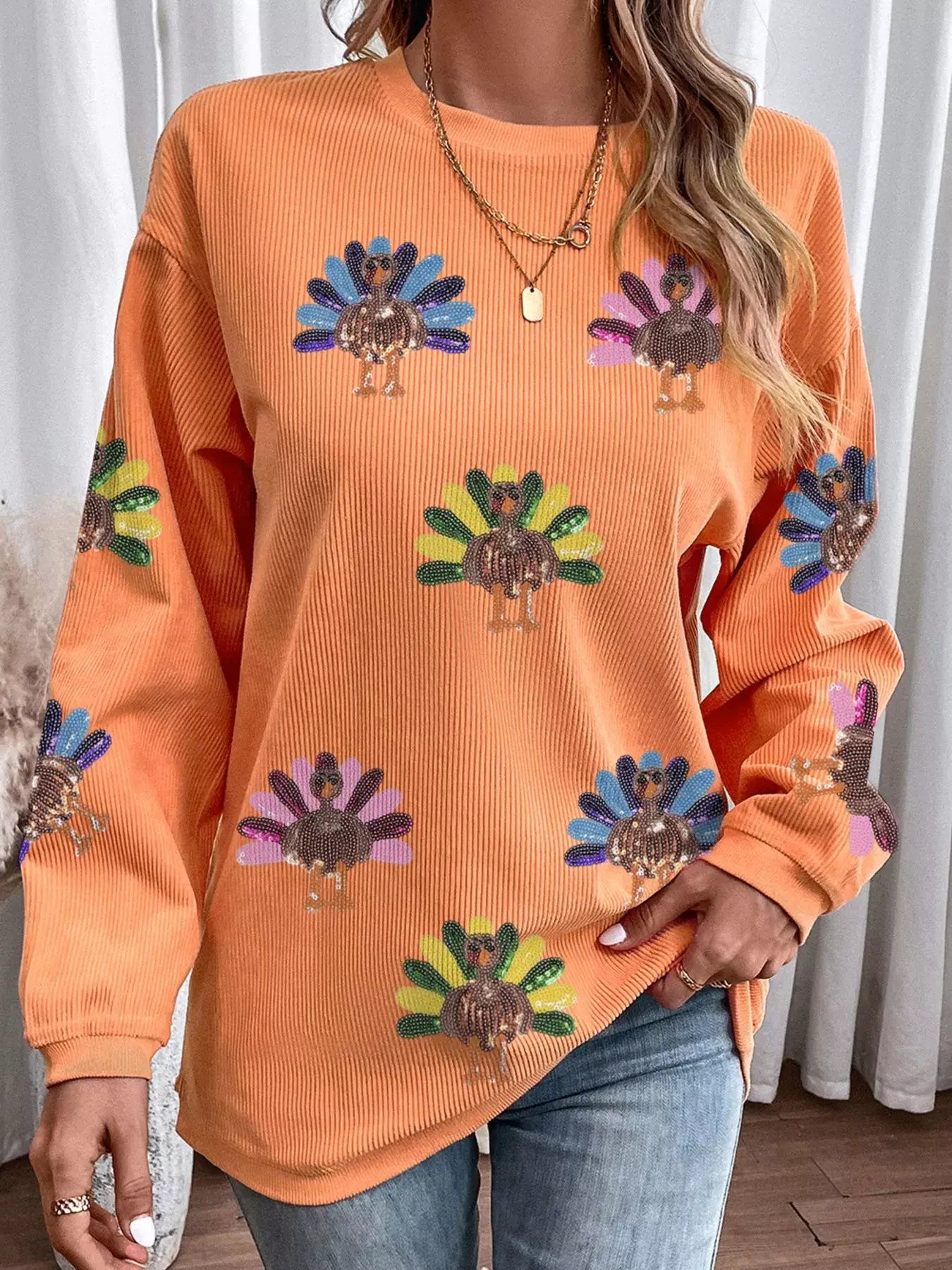 Turkey Graphic Corded Baggy Sweatshirt in orange with playful turkey graphic design for cozy outfits.