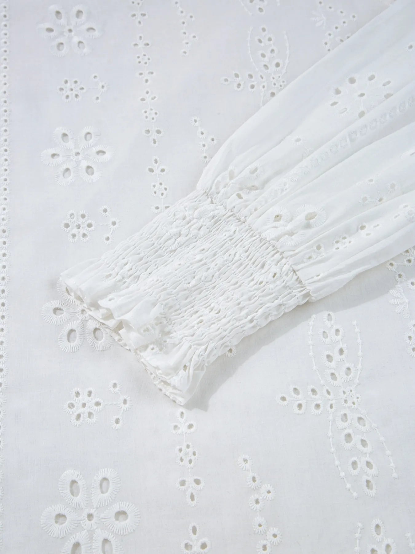 Close-up of Eyelet Long Sleeve Blouse with Elastic Cuffs for Women showcasing detailed fabric and elastic cuff design.
