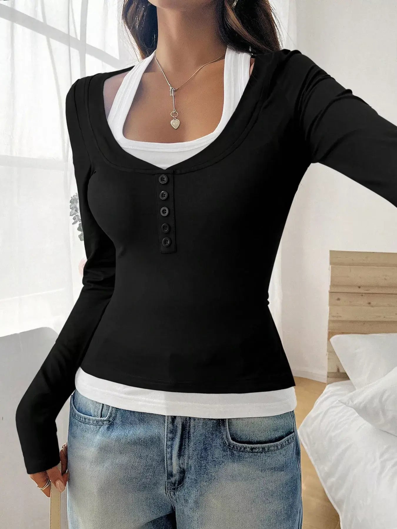 Chic scoop neck long sleeve t-shirt in black with buttons, styled for comfort and effortless fashion.