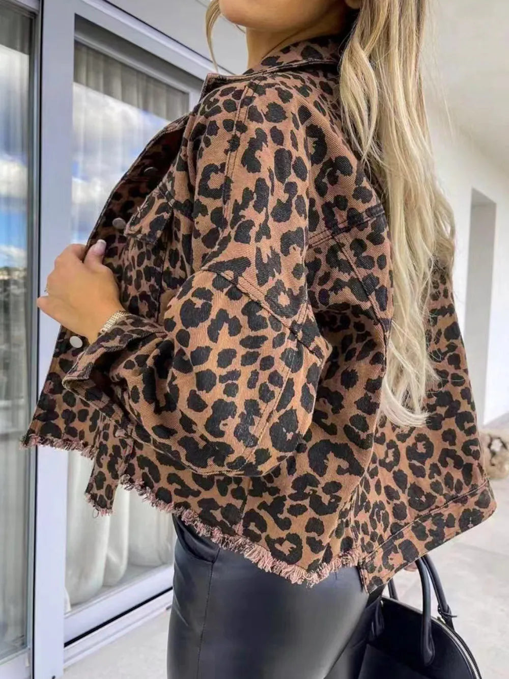 Raw Hem Leopard Collared Neck Denim Jacket worn casually showing the leopard print and raw hem design.